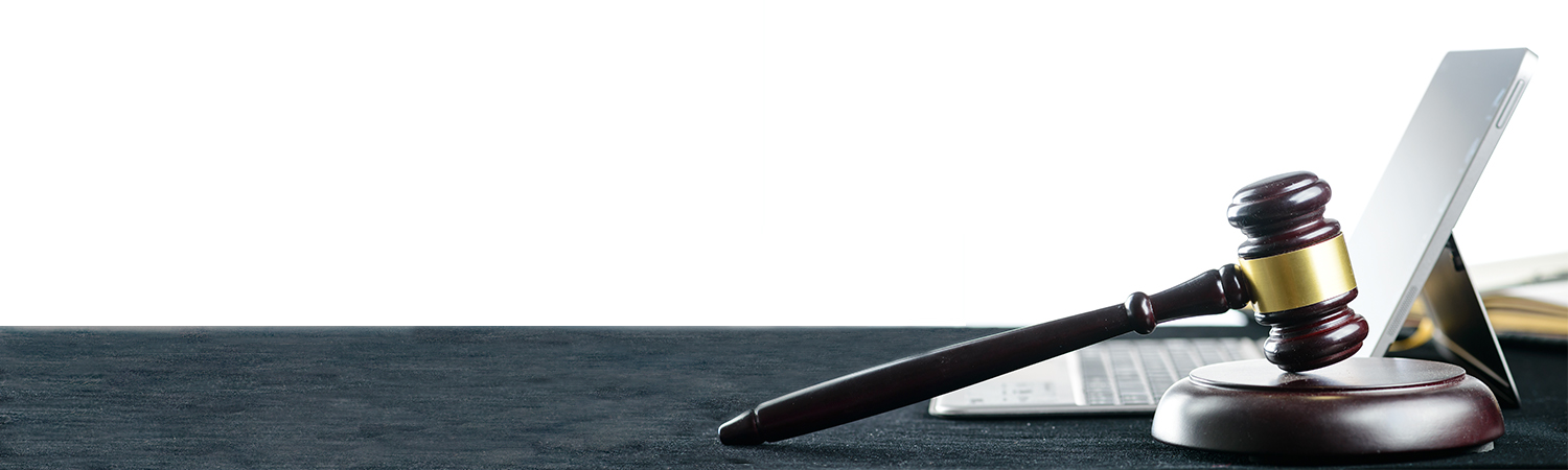 Gavel and Laptop on a Felt Surface